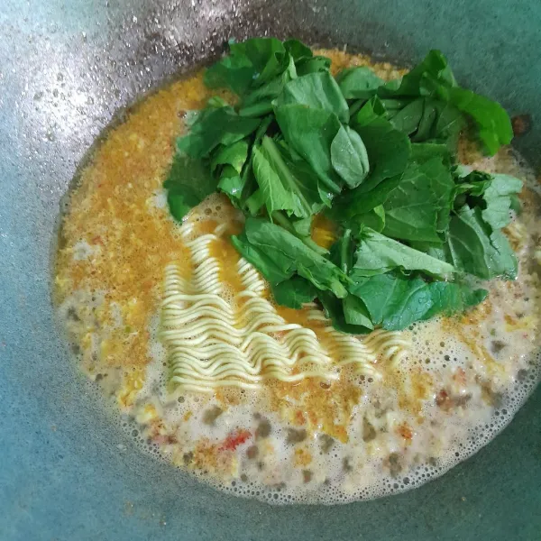 Masukkan mie dan sawi hijau aduk rata