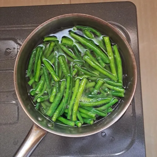 Lalu rebus 50 gram kacang panjang yang sudah dibersihkan, lalu tiriskan jika kacang panjang setengah matang