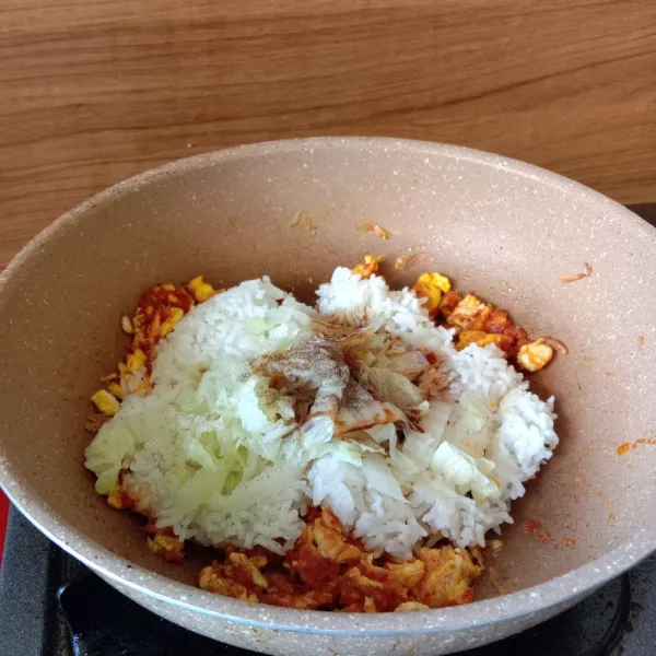 Tambahkan bumbu dasar merah, nasi, sawi putih yang sudah di rebus, garam, kaldu bubuk, kecap manis, merica bubuk dan minyak wijen. aduk rata.