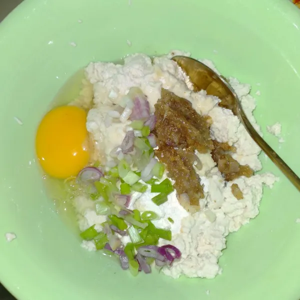 Campurkan tahu, bawang merah, bawang putih yang sudah digoreng, daun bawang, kelapa parut muda, tepung terigu, dan telur hingga merata.