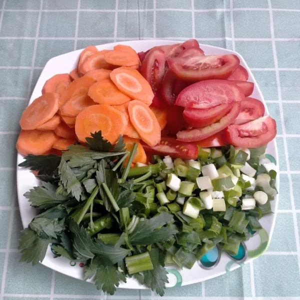 Cuci dan potong-potong wortel, tomat, daun bawang, dan daun seledri