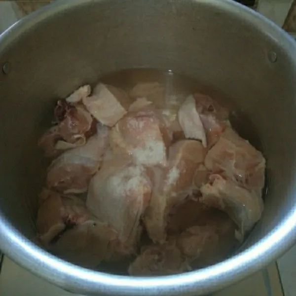 Cuci bersih ayam. Siapkan panci berisi air lalu masukkan ayam dan 1 sdt garam. Rebus selama 20 menit lalu buang air bekas rebusannya.