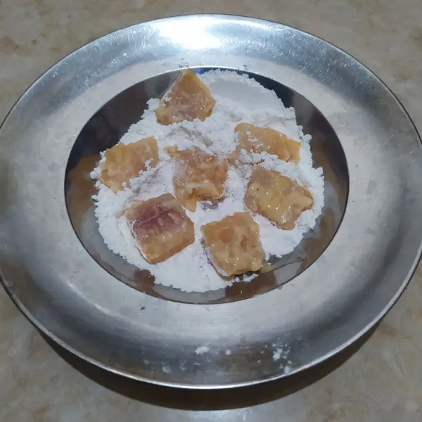 Baluri ikan dengan bahan pelapis hingga rata.