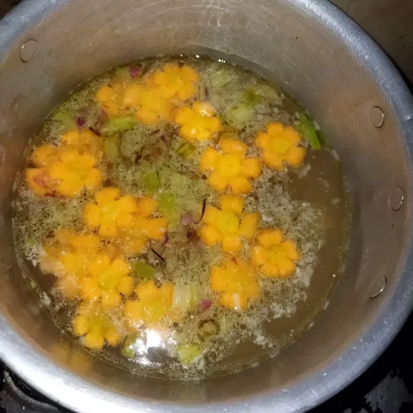 Tambahkan air kaldu, tunggu sampai berbuih, kemudian masukkan wortel, masak sampai wortel matang.