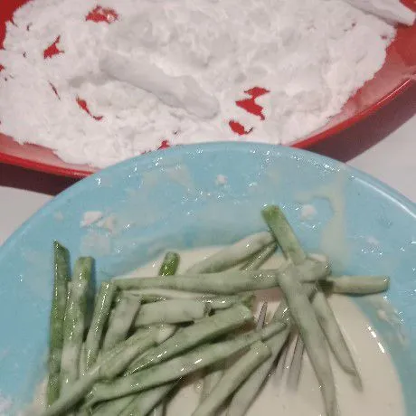 Campur tepung bumbu serbaguna dan telur jadi satu. Tambahkan air bertahap. Celupkan buncis pada tepung basah lalu gulingkan di tepung maizena