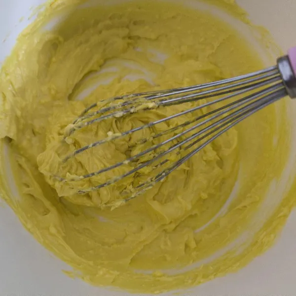 Campur margarin dan gula halus menggunakan whisk.