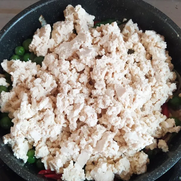 Masukkan tahu, kemudian aduk rata. Tumis sebentar.