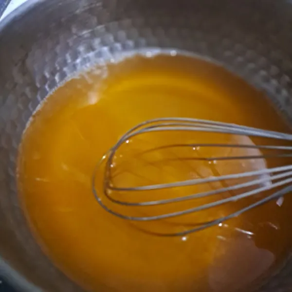 Masak jelly dan gula sesuai petunjuk kemasan sampai mendidih, lalu biarkan sampai uap hilang.