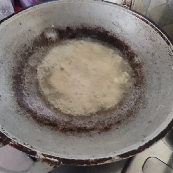 Masukkan tempe dalam adonan marinasi sebentar, lalu goreng di minyak panas dan tuangkan adonan dari agak atas.