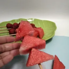 Langkah kedua, potong-potong buah semangka. Tusuk-tusuk juga menggunakan tusukan sate.
