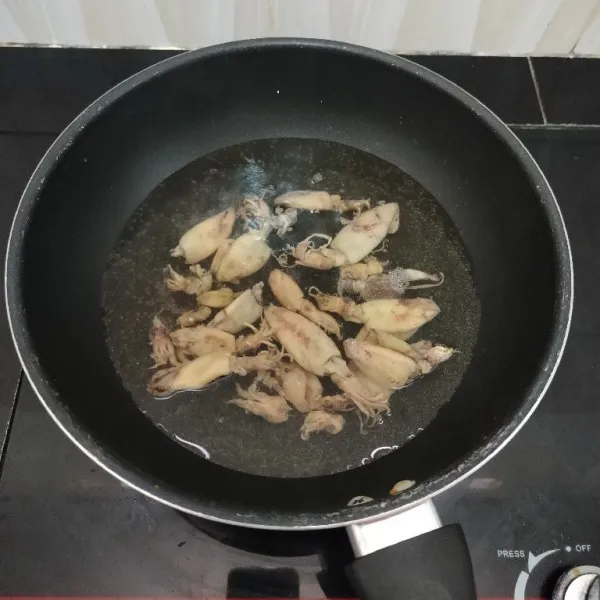 Cuci bersih cumi asin. Lalu rebus dalam air mendidih selama 5 menit. Angkat dan tiriskan.