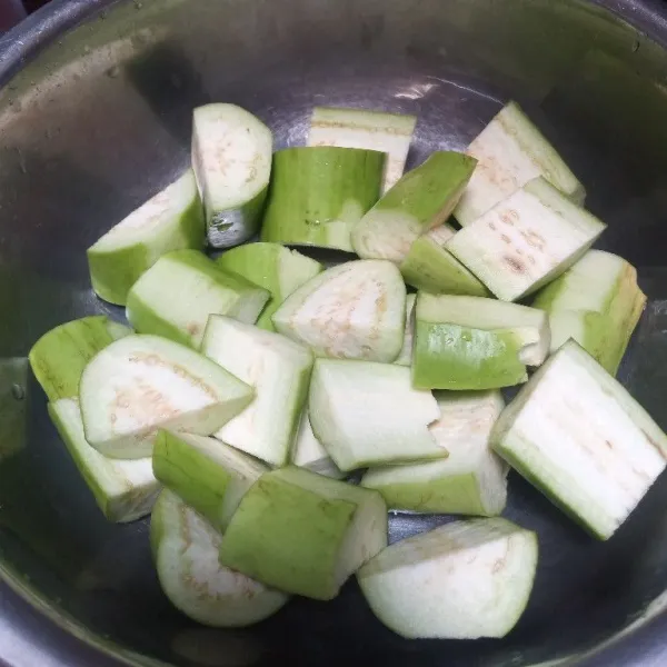 Potong-potong terong, langsung rendam di air beberapa saat, kemudian bilas.