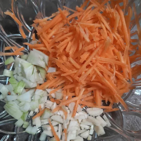 Potong-potong bawang bombay, lalu serut wortel.