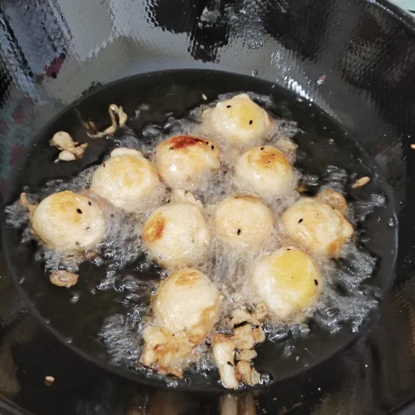 Panaskan minyak goreng, lalu goreng adonan tape hingga berubah warna menjadi kuning keemasan.