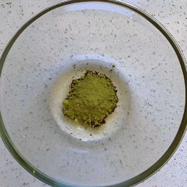 Masukkan 20 gr minyak jagung dan 3 gr bubuk matcha ke dalam mangkuk, lalu aduk rata.