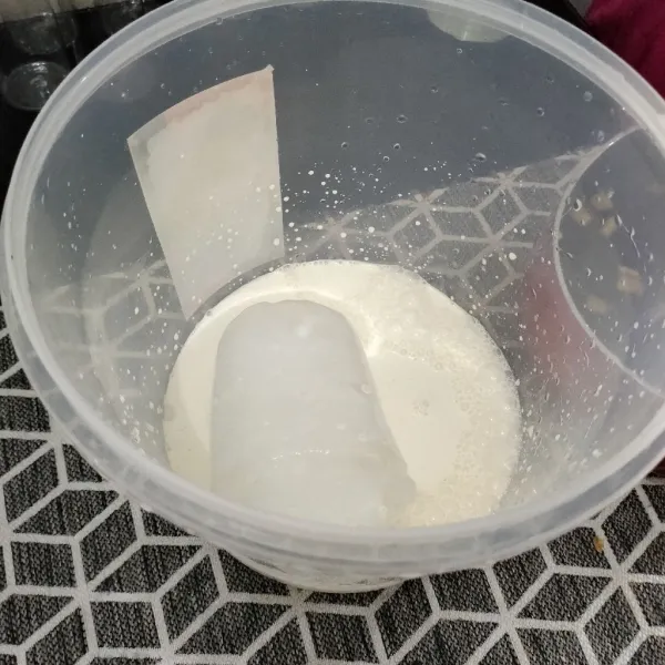 Siapkan es batu dan masukkan susu evaporasi, aduk sampai rata.
