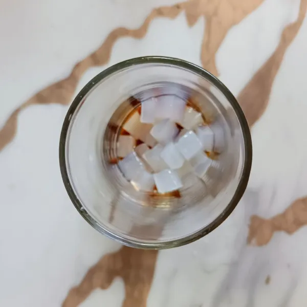 Dalam gelas, masukkan madu dan nata de coco.