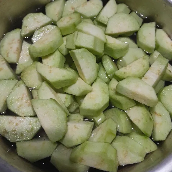 Kupas dan potong terong sesuai selera, rendam dalam air garam.