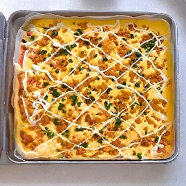 Taburkan abon, daun bawang, serta sosis di atas permukaan. Tambahkan saus mayonaise secukupnya. Panaskan oven hingga 150°C, lalu panggang selama 30 menit.