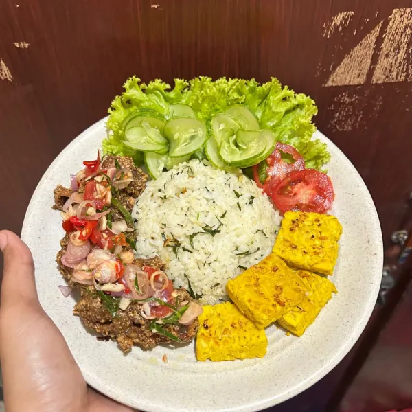 nasi daun jeruk dengan ayam goreng ketumbar sambal matah dan tempe panggang siap disajikan.
