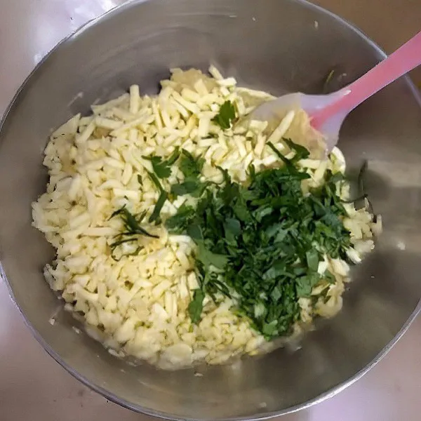 Masukkan 100 gr keju parut dan 10 gr parsley cincang, aduk hingga tercampur rata.