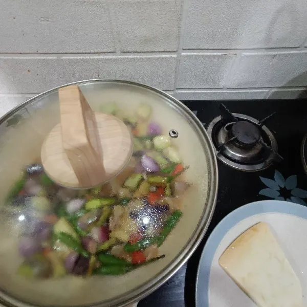Tuangkan sedikit air, lalu tutup panci dan masak selama 2 menit hingga pinggiran tumisan berbusa atau mendidih.