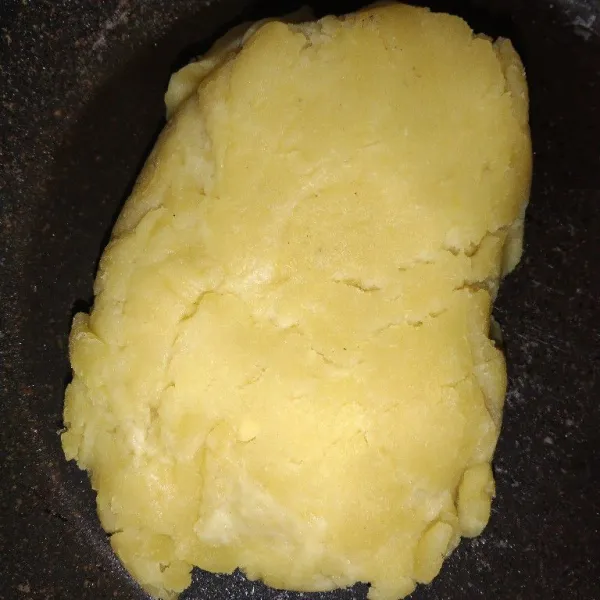 Masukkan tepung terigu, lalu aduk hingga adonan terbentuk.