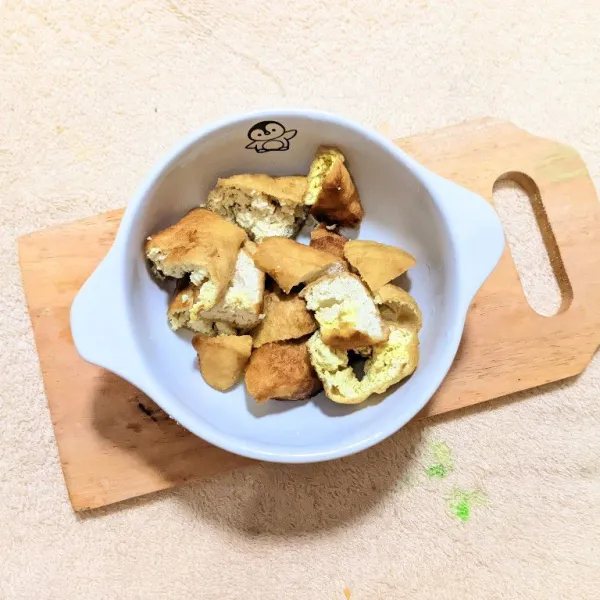Potong-potong tahu goreng, lalu letakkan di mangkuk saji.