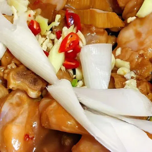 Panaskan minyak goreng dalam wajan, masukkan ayam yang sudah dimarinasi, tumis hingga berubah warna dan airnya hampir habis. Tambahkan bawang bombay dan cabe merah kecil, lalu tumis hingga harum.