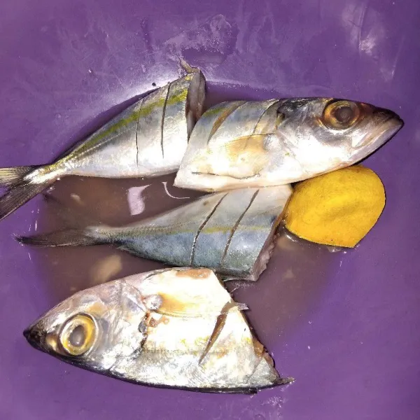 Bersihkan ikan, lalu potong-potong dan beri air jeruk nipis. Diamkan selama beberapa menit, lalu bilas kembali.