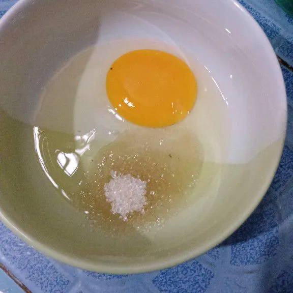 Kocok telur beserta dengan gula pasir dalam wadah lain.