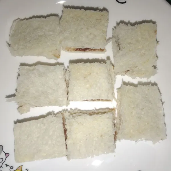 Tutup dengan roti lain, lalu potong menjadi 4 bagian.