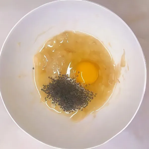 Masukkan 90 gr pisang halus, 1 butir telur, dan 5 gr wijen hitam ke dalam mangkuk. Aduk hingga tercampur rata